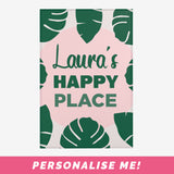 Custom area rug front with happy place slogan and tropical leaves.