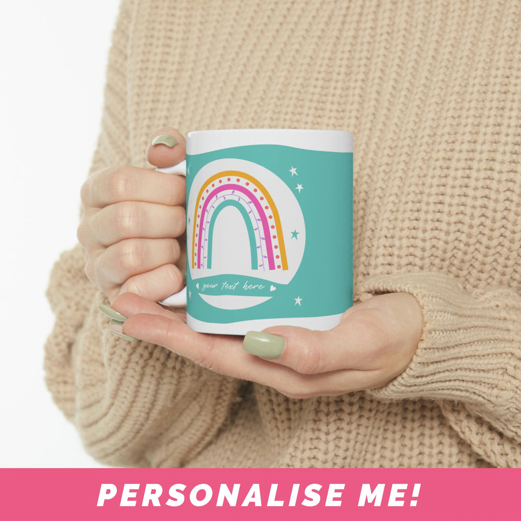 Personalized name mugs with a rainbow design and blue background.